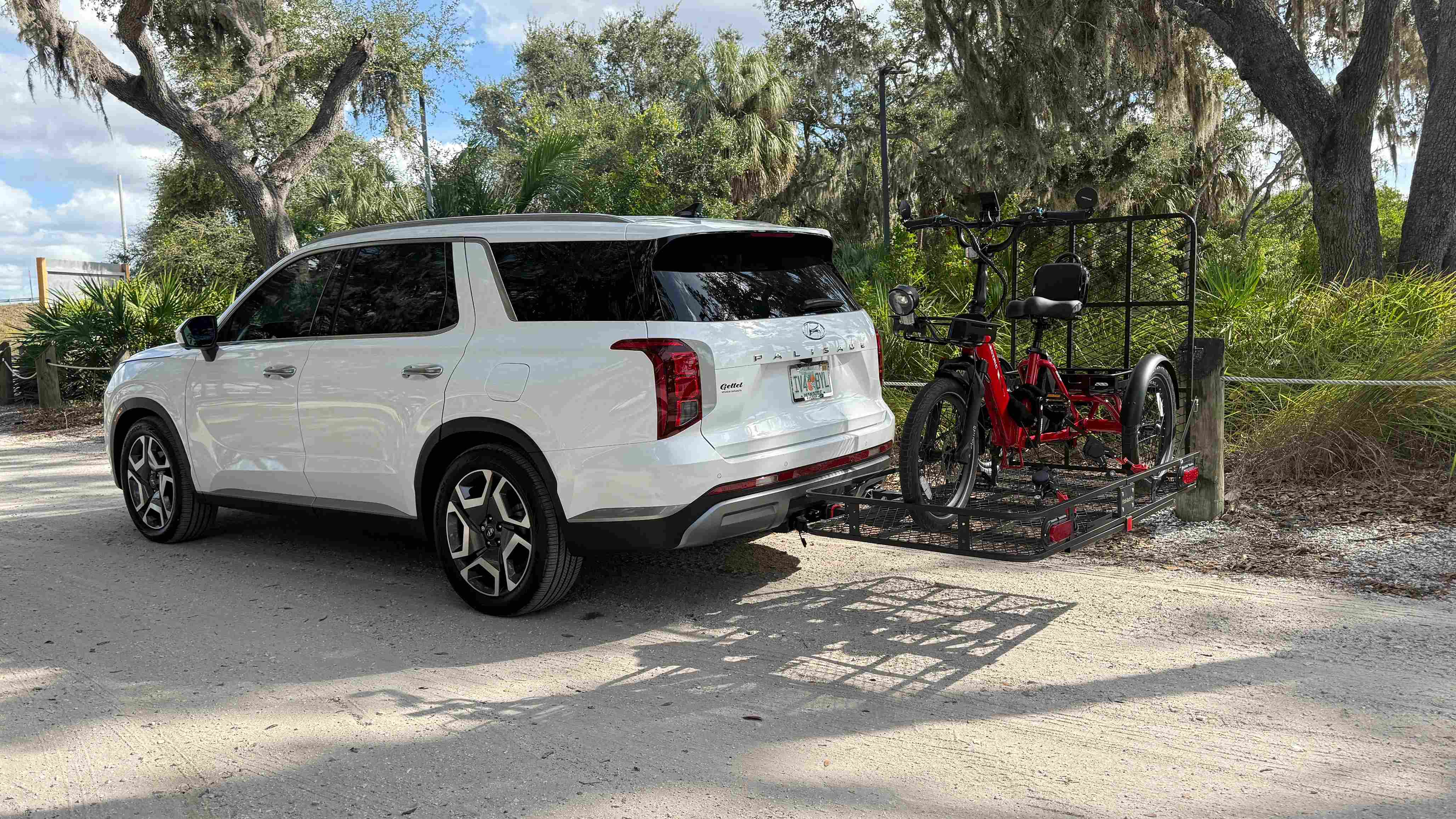 Electric trike loaded onto a vehicle hitch cargo rack.