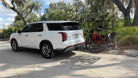 Electric trike loaded onto a vehicle hitch cargo rack.