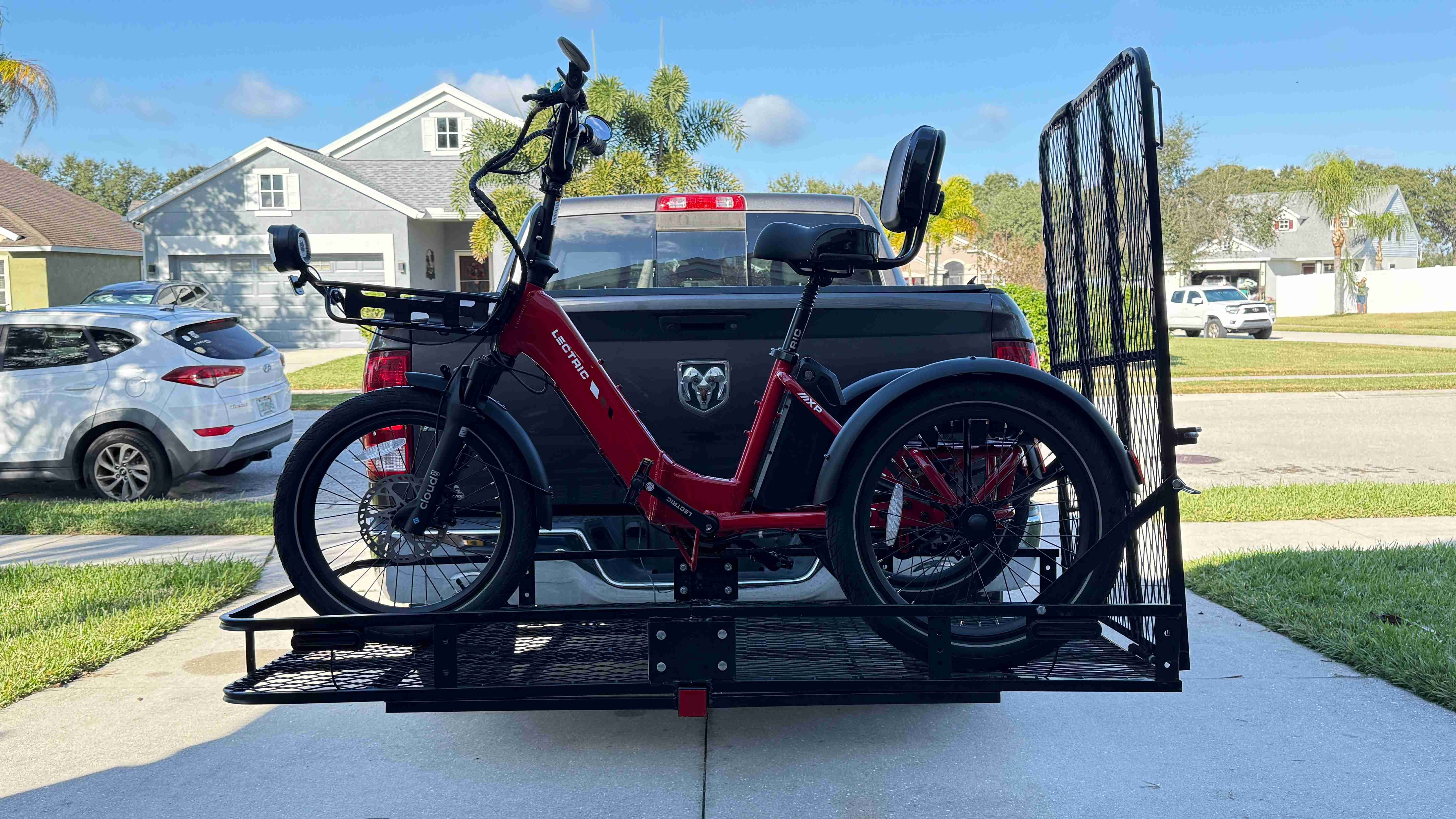 Red Lectric XP Trike loaded on a Hitch Rack Pro platform carrier behind a truck